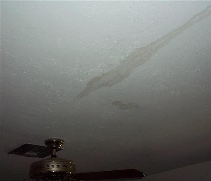 water stain in the ceiling by a fan