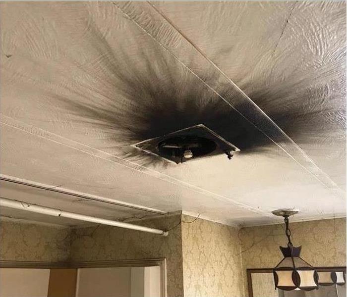 soot-stained ceiling with spider-like smoke and soot webbing